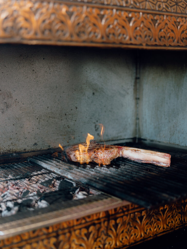 Sharing steak over charcoal